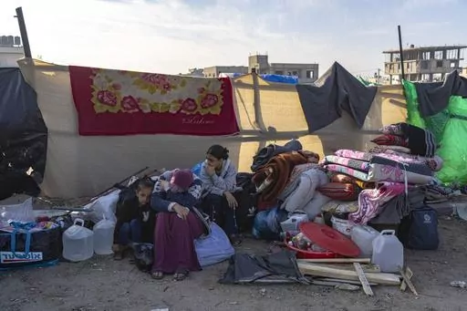 Palestinians displaced by the Israeli bombardment of the Gaza Strip gather at a tent camp, in Rafah, southern Gaza strip, Monday, Dec. 4, 2023. Hundreds of thousands of Palestinians have fled their homes as Israel moves ahead with a ground offensive against the ruling Hamas militant group. (AP Photo/Fatima Shbair)
