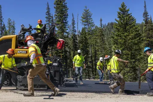 Construction take place on the Teton Pass on Tuesday, June 25, 2024 near Jackson, Wyo. Wyoming officials are expected to reopen this week a large chunk of a mountain pass highway in Wyoming that collapsed earlier this month, severing a well-traveled commuter link between small towns in eastern Idaho and the tourist destination of Jackson. Wyoming officials will provide media with a tour of the area on Tuesday. (AP Photo/Natalie Behring)