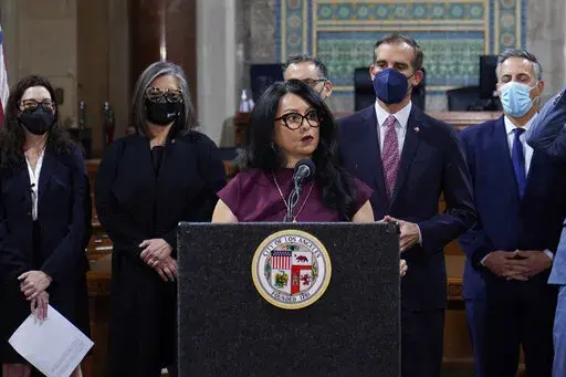 Los Angeles City Council President Nury Martinez at podium, and Mayor Eric Garcetti, standing to her right, are seen during a news conference at Los Angeles City Hall in Los Angeles on April 1, 2022. The president of the Los Angeles City Council resigned from the post Monday, Oct. 10, 2022, after she was heard making racist comments and other coarse remarks in a leaked recording of a conversation with other Latino leaders. Council President Nury Martinez issued an apology and expressed shame. (A
