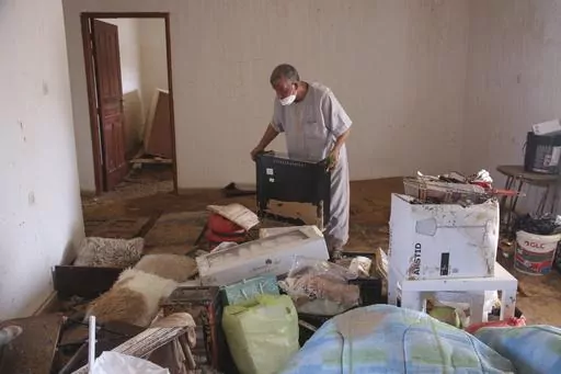 Derna flood survivor Abdul Salam Anwisi cleans his home after flooding caused by Mediterranean storm Daniel, in Derna, Libya, Sunday, Sept. 17, 2023. Anwisi said he woke up at one-thirty in the morning to a scream from outside, to find his neighbours' homes flooded with water. He, his sons, and other neighbours rushed to rescue the stranded families by pulling them from the roof of their house. Thousands of Libyans have lost family members, friends and neighbors in the devastating floods that en