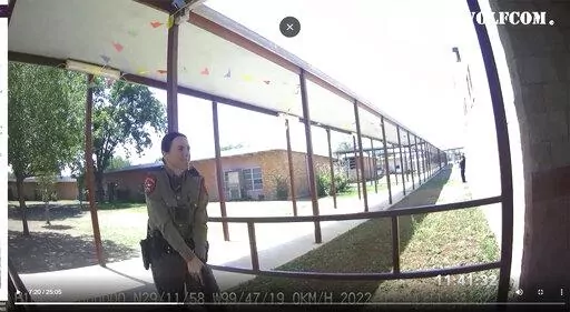 This image from video released by the City of Uvalde, Texas shows Texas Department of Public Safety trooper Crimson Elizondo responding to a shooting at Robb Elementary School, on May 24, 2022 in Uvalde, Texas.  The former Texas state trooper under investigation for the law enforcement response to the deadly school shooting in Uvalde has been hired by the school district as a campus police officer. (City of Uvalde via AP)