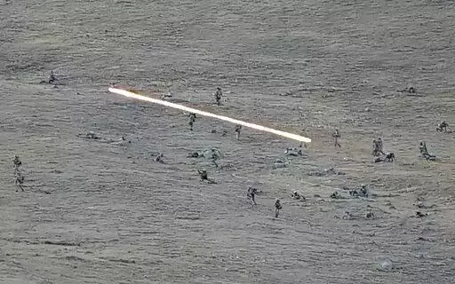 In this image taken from a YouTube footage released by Armenian Defense Ministry on Tuesday, Sept. 13, 2022, shows Azerbaijanian servicemen crossing the Armenian-Azerbaijani border and approaching the Armenian positions. Armenia's prime minister says that 49 soldiers have been killed in nighttime attacks by Azerbaijan. (Armenian Defense Ministry via AP)