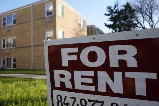 A "For Rent" sign displays outside apartment building in Skokie, Ill., Sunday, April 14, 2024. Renters can personalize their living spaces for greater comfort and style without jeopardizing their security deposits. Removable wallpaper, rugs and curtains offer temporary yet impactful ways to add color and design. Upgrading cabinet hardware and light fixtures provides a budget-friendly refresh and elevates the overall feel of a room. (AP Photo/Nam Y. Huh)