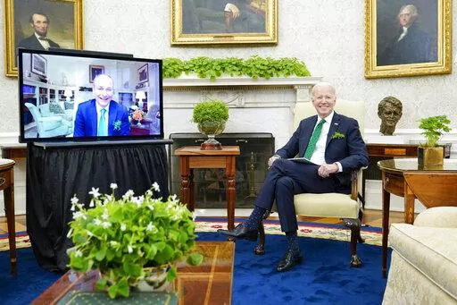 President Joe Biden meets virtually with Irish Prime Minister Micheál Martin in the Oval Office of the White House, Thursday, March 17, 2022, in Washington. Martin tested positive for COVID-19 Wednesday. (AP Photo/Patrick Semansky)