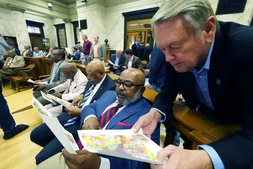 Sen. Kelvin Butler, D-McComb, left, confers with Rep. Bill Pigott, R-Tylertown, during a meeting of the House Legislative Reapportionment Committee, Sunday, March 27, 2022, at the Mississippi Capitol in Jackson. (AP Photo/Rogelio V. Solis)
