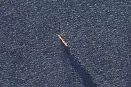 In this satellite image provided by Planet Labs, the Belize-flagged bulk carrier Rubymar is seen in the southern Red Sea near the Bay el-Mandeb Strait leaking oil after an attack by Yemen's Houthi rebels Tuesday, Feb. 20, 2024. Despite a month of U.S.-led airstrikes, Yemen's Iran-backed Houthi rebels remain capable of launching significant attacks. This week, they seriously damaged a ship in a crucial strait and apparently downed an American drone worth tens of millions of dollars. (Planet Labs 