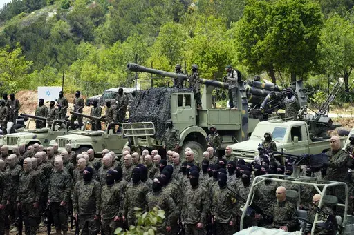 Fighters from the Lebanese militant group Hezbollah carry out a training exercise in Aaramta village in the Jezzine District, southern Lebanon, Sunday, May 21, 2023. Thousands of fighters from Iran-backed groups in the Middle East are offering to come to Lebanon to join the militant Hezbollah group in its fight with Israel. (AP Photo/Hassan Ammar, File)