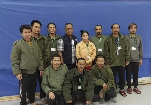 In this photo provided by Thailand's Foreign Ministry, ten of freed Thai hostages and an officer, fourth from left, pose for a photo at the Shamir Medical Center in Israel Friday, Nov. 24, 2023. Hamas freed 10 Thai nationals seized in the group’s surprise attack on southern Israel last month, releasing them alongside Israeli hostages who were part of the first swap under a new cease-fire deal.(Thailand's Foreign Ministry via AP )