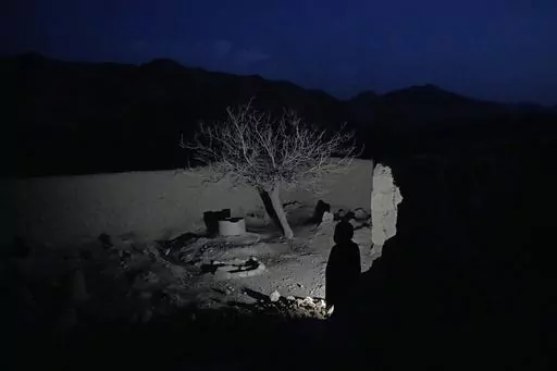 A boy who lost his parents and five of his siblings during a Sept. 5, 2019, night raid by U.S. forces, stands in the yard of their home that was destroyed in the attack in a remote region of Afghanistan, on Friday, Feb. 24, 2023. What exactly happened that fall night is at the center of a bitter international custody dispute over an orphaned baby found amid the rubble. The high-profile legal battle pits an Afghan family against an American one, and has drawn responses from the White House and th