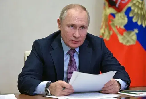 Russian President Vladimir Putin attends a cabinet meeting via video conference at the Novo-Ogaryovo residence outside Moscow, Russia, Friday, Dec. 24, 2021. (Alexei Nikolsky, Sputnik, Kremlin Pool Photo via AP)