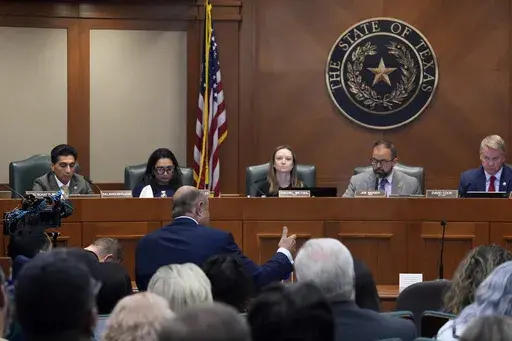 Dr. Phil McGraws, in blue suit gesturing with hand, makes comments during a committee hearing in the case of death row inmate Robert Roberson, Monday, Oct. 21, 2024, in Austin, Texas. (AP Photo/Tony Gutierrez)