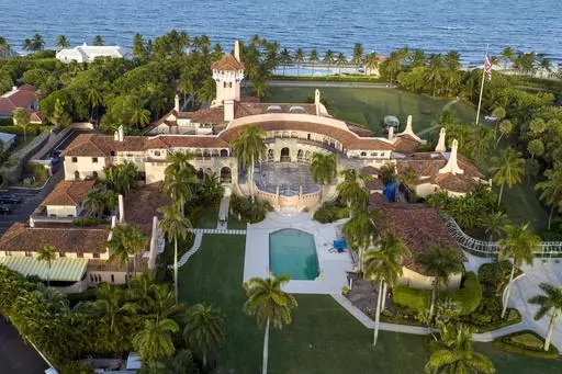 An aerial view of President Donald Trump's Mar-a-Lago estate is seen Aug. 10, 2022, in Palm Beach, Fla. A third defendant has been charged alongside former President Donald Trump and his valet in the classified documents case in Florida, court records show. (AP Photo/Steve Helber, File)