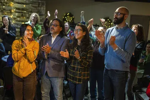 U.S. Rep. Mary Peltola, center, celebrates with her family and supporters as ranked-choice tabulations were announced on Wednesday, Nov. 23, 2022 at 49th State Brewing Company in Anchorage, Alaska. Peltola has been elected to a full term in the House, months after the Alaska Democrat won a special election to the seat following the death earlier this year of longtime Republican Rep. Don Young. (Loren Holmes/Anchorage Daily News via AP)