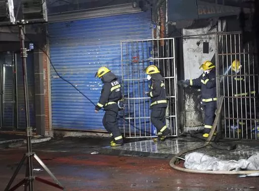 Firefighters work at the site of a building fire in Xinyu City, east China's Jiangxi Province, Wednesday, Jan. 24, 2024. Chinese state media say at least 39 people died and nine others were injured after a fire broke out in southeastern Jiangxi province. State broadcaster CCTV reported that local authorities said that the fire broke out Wednesday afternoon. The building houses an internet cafe in the basement and tutoring centers on upper floors. Local government officials were deployed to the s