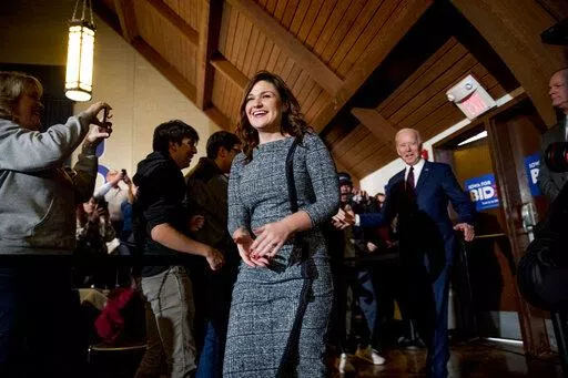 In this Saturday, Jan. 18, 2020 file photo, Rep. Abby Finkenauer, D-Iowa, left, and then Democratic presidential candidate former Vice President Joe Biden, arrive at a campaign stop at Simpson College in Indianola, Iowa. A state court judge has concluded that Democrat Abby Finkenauer cannot appear on the June 7 primary ballot for U.S. Senate, knocking off the candidate considered by many to be the party's leader in the effort to challenge U.S. Sen. Charles Grassley. (AP Photo/Andrew Harnik, File