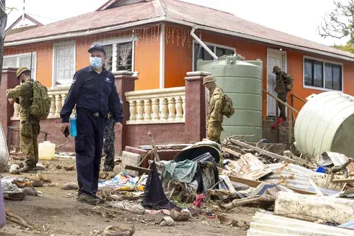 In this photo provided by the Australian Defence Force, Australian Defence Force and Department of Foreign Affairs & Trade crisis response team personnel make a damage assessment operation in Nuku'alofa, on Atata island in Tonga,  following the eruption of underwater volcano, on Feb. 4, 2022. (CPL Robert Whitmore/Australian Defence Force via AP)