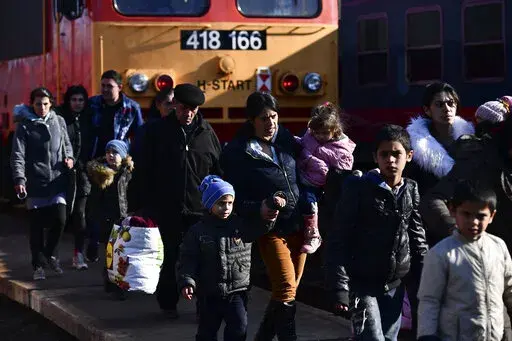 Refugees fleeing conflict from neighboring Ukraine arrive to Zahony, Hungary, Sunday, Feb. 27, 2022. As hundreds of thousands of Ukrainians seek refuge in neighboring countries, cradling children in one arm and clutching belongings in the other, leaders in Poland, Hungary, Bulgaria, Moldova and Romania are offering a hearty welcome. (AP Photo/Anna Szilagyi, File)