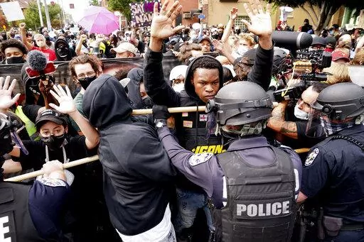 Police and protesters converge during a demonstration, Wednesday, Sept. 23, 2020, in Louisville, Ky.  Recent revelations about the search warrant that led to Breonna Taylor’s death have reopened old wounds in Louisville’s Black community and disrupted the city’s efforts to restore trust in the police department. (AP Photo/John Minchillo, File)
