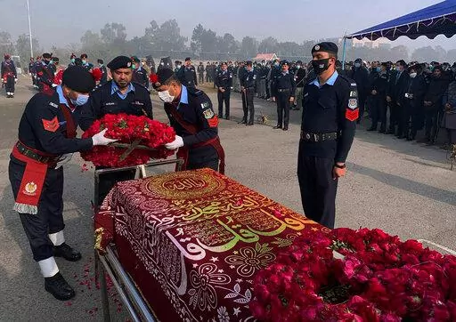 FILE- Police officers attend the funeral prayer of a colleague who was killed in an overnight attack by Pakistani Taliban who targeted police in multiple attacks in Islamabad and elsewhere in the country's northwest, in Islamabad, Pakistan, Jan. 18, 2022. Faced with rising violence, Pakistan is taking a tougher line to pressure Afghanistan’s Taliban rulers to crack down on militants hiding on their soil, but so far the Taliban remain reluctant to take action -- trying instead to broker a peace