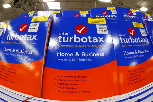 This Thursday, Feb. 22, 2018 photo shows a display of TurboTax software in a Sam's Club in Pittsburgh.  Under the terms of a settlement signed by the attorneys general of all 50 states, Mountain View, California-based Intuit Inc. will suspend TurboTax’s “free, free, free” ad campaign and pay restitution to nearly 4.4 million taxpayers, New York Attorney General Letitia James said, Wednesday, May 4, 2022.(AP Photo/Gene J. Puskar)