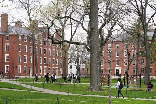 Students walk through Harvard Yard, April 27, 2022, on the campus of Harvard University in Cambridge, Mass. On Monday, July 24, 2023, the U.S. Department of Education opened an investigation into Harvard University's policies on legacy admissions, which give an edge to applicants with family ties to alumni. (AP Photo/Charles Krupa, File)