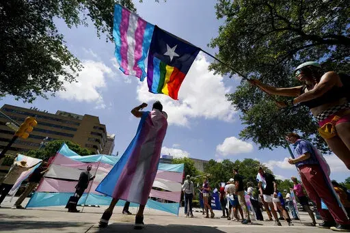 Demonstrators gather on the steps to the State Capitol to speak against transgender-related legislation bills being considered in the Texas Senate and House, May 20, 2021, in Austin, Texas. A federal ruling on Aug. 16, 2022, that gender dysphoria is covered by the Americans with Disabilities Act, could help block conservative political efforts to restrict access to gender-affirming care, advocates and experts say. (AP Photo/Eric Gay, File)