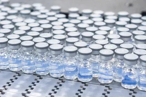 This August 2022 photo provided by Pfizer shows vials of the company's updated COVID-19 vaccine during production in Kalamazoo, Mich.  
 U.S. regulators have authorized updated COVID-19 boosters, the first to directly target today's most common omicron strain. The move on Wednesday, Aug. 13, 2022,  by the Food and Drug Administration tweaks the recipe of shots made by Pfizer and rival Moderna  that already have saved millions of lives.  (Pfizer via AP)
