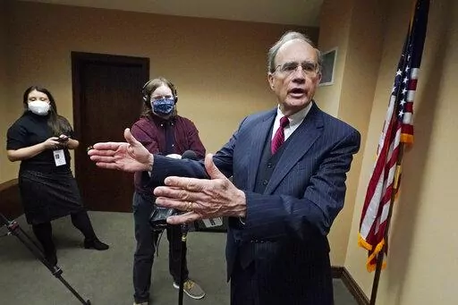 Mississippi Lt. Gov. Delbert Hosemann tells reporters Tuesday, Jan. 4, 2022, that the state should provide health insurance for working people, but sharply rebuffed a question about expanding Medicaid, at the Mississippi State Capitol in Jackson, Miss., following the start of the latest Legislative Session, Tuesday, Jan. 4, 2022. (AP Photo/Rogelio V. Solis)