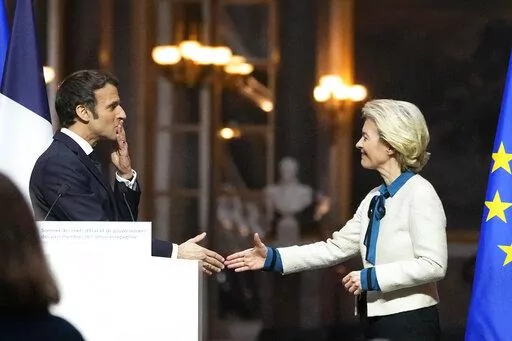 French President Emmanuel Macron blows a kiss to European Commission President Ursula von der Leyen after a joint press conference after the EU summit at the Chateau de Versailles, Friday, March 11, 2022 in Versailles, west of Paris. The European Union says it will continue applying pressure on Russia by devising a new set of sanctions to punish Moscow for its invasion of Ukraine while stepping up military support for Kyiv. (AP Photo/Michel Euler)