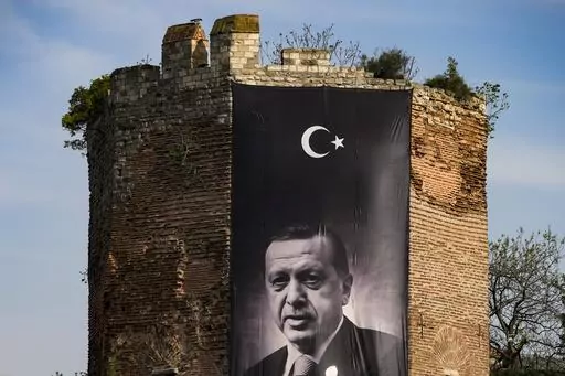 A giant banner of Turkish President and People's Alliance's presidential candidate Recep Tayyip Erdogan is displayed on an historical city wall, in Istanbul, Turkey, Saturday, April 22, 2023. Two opposing visions for Turkey’s future are on the ballot when voters return to the polls Sunday for a runoff presidential election, which will decide between an increasingly authoritarian incumbent President Recep Tayyip Erdogan and challenger Kemal Kilicdaroglu, who has pledged to restore democracy. (A