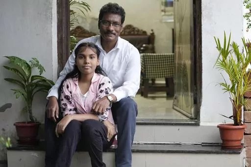 Gautam Dongre, of the National Alliance of Sickle Cell Organizations, sits for a portrait with his daughter, Sumedha, 13, at their residence in Nagpur, India, Wednesday, Dec. 6, 2023. Dongre recalls how his newborn son, Girish, cried constantly from stomach and leg pain. Doctors couldn’t figure out what was wrong and didn’t diagnose him with sickle cell for 2 1/2 years. When Sumedha was born, he and his wife had her tested immediately and learned she had the disease too. (AP Photo/Ajit Solan