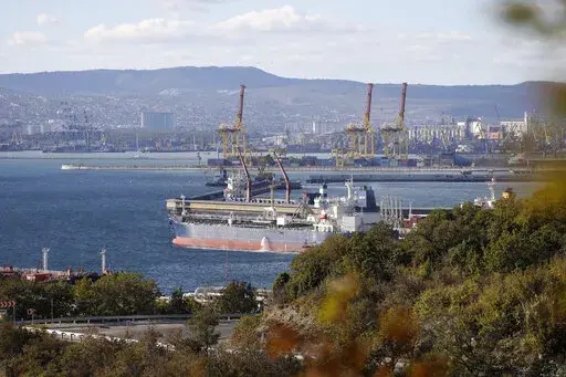 FILE An oil tanker is moored at the Sheskharis complex, part of Chernomortransneft JSC, a subsidiary of Transneft PJSC, in Novorossiysk, Russia, Tuesday, Oct. 11, 2022, one of the largest facilities for oil and petroleum products in southern Russia. The European Union is edging closer to a $60-per-barrel price cap on Russian oil. It's a highly anticipated and complex political and economic maneuver designed to keep Russian oil flowing into global markets while clamping down on President Vladimir