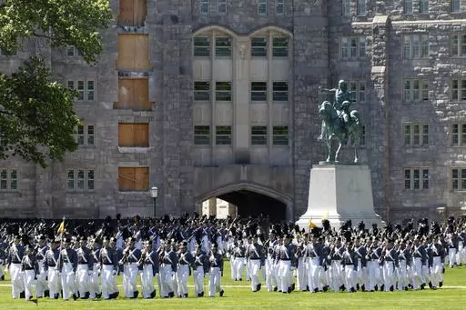 In this May 22, 2019 photo members of the senior class march past a statue of George Washington during Parade Day at the U.S. Military Academy in West Point, N.Y. "Duty, Honor, County" has been the motto of the U.S. Military Academy at West Point since 1898. The motto isn't changing, but a decision to take those words out of the school's lesser-known mission statement is generating outrage in certain quarters. (AP Photo/Mark Lennihan, File)