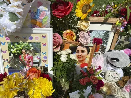 Flowers, candles and photos are placed near Mamta Kafle Bhatt's mailbox in Manassas Park, Va., Sept. 4, 2024. (AP Photo/Olivia Diaz, File)