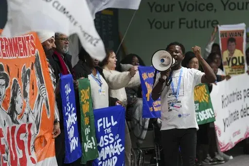 Activists participate in a demonstration calling for climate finance during the COP29 U.N. Climate Summit, Thursday, Nov. 14, 2024, in Baku, Azerbaijan. (AP Photo/Peter Dejong)