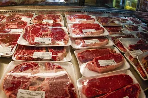 In this photo made on June 16, 2022, rows of fresh cut beef is in the coolers of the retail section at the Wight's Meat Packing facility in Fombell, Pa. Federal agriculture officials on Monday, March 6, 2023 released new requirements that would allow labels on meat, poultry or eggs to claim that phrase -- or “Product of USA” -- only if they come from animals “born, raised, slaughtered and processed in the United States.” (AP Photo/Keith Srakocic, File )