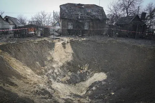 A general view of the crater at a site of recent Russian missile attack in Kyiv, Ukraine, Monday, Dec. 11, 2023. (AP Photo/Efrem Lukatsky)