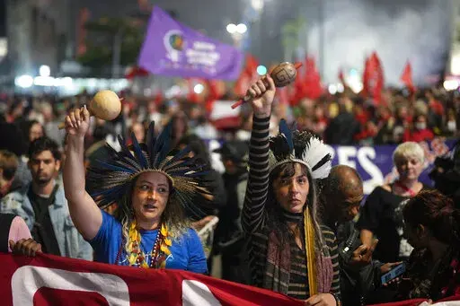 Guarani Indigenous women protest calling for protection of the nation's democracy in Sao Paulo, Brazil, Monday, Jan. 9, 2023, a day after supporters of former President Jair Bolsonaro stormed government buildings in the capital. (AP Photo/Andre Penner)