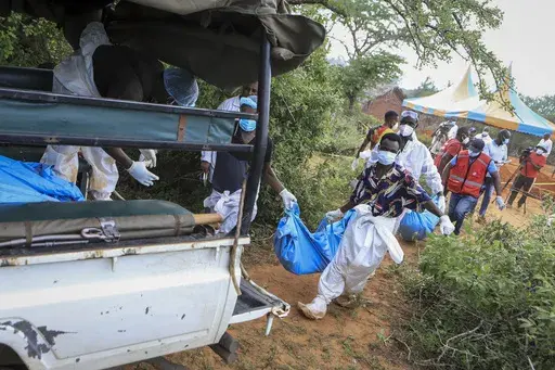 Police and local residents load the exhumed bodies of victims of a religious cult into the back of a truck in the village of Shakahola, near the coastal city of Malindi, in southeastern Kenya Sunday, April 23, 2023. Dozens of bodies have been discovered so far in shallow graves in a forest near land owned by a pastor Paul Makenzi in coastal Kenya who was arrested for telling his followers to fast to death. (AP Photo)
