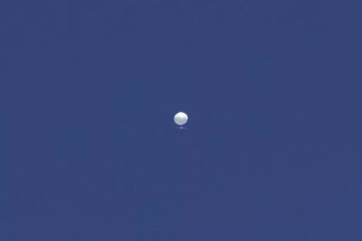 A balloon floats over Columbia, Mo., on Friday, Feb. 3, 2023. A huge, high-altitude Chinese balloon sailed across the U.S. on Friday, drawing severe Pentagon accusations of spying despite China's firm denials. (Anna Griffin/Missourian via AP)