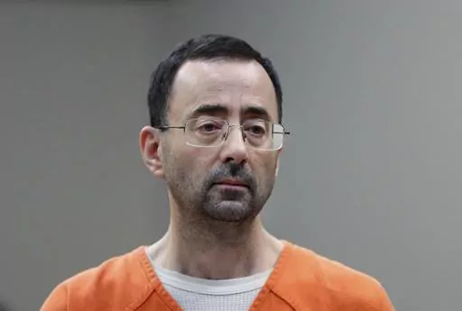 Dr. Larry Nassar, 54, appears in court for a plea hearing in Lansing, Mich., on Nov. 22, 2017. Recent assaults on two notorious, high-profile federal prisoners have renewed concerns about whether the federal Bureau of Prisons is capable of keeping people in its custody safe. Nassar was knifed repeatedly in his cell at a federal penitentiary in Florida in July. (AP Photo/Paul Sancya, File)