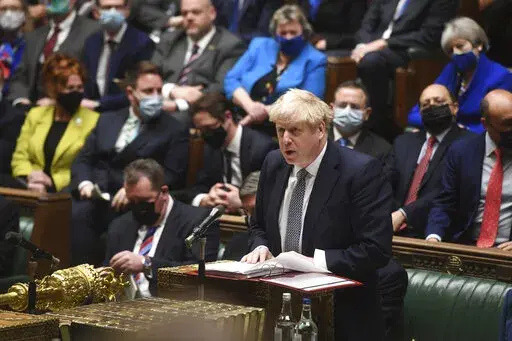 In this photo provided by UK Parliament, Britain's Prime Minister Boris Johnson speaks during Prime Minister's Questions in the House of Commons, in London, Wednesday, Jan. 12, 2022. Johnson has apologized for attending a garden party during Britain’s first coronavirus lockdown, but brushed aside opposition demands that he resign for breaching the rules his own government had imposed on the nation. The apology Wednesday stopped short of admitting wrongdoing. It was Johnson’s attempt to assua
