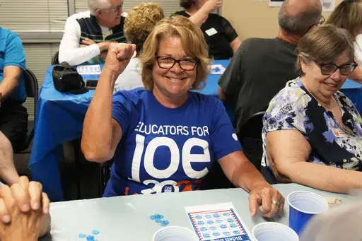 Michele Smith wins a game of bingo at a campaign event for seniors in support of President Joe Biden's reelection campaign, Thursday, June 13, 2024, in Phoenix. (AP Photo/Rick Scuteri)