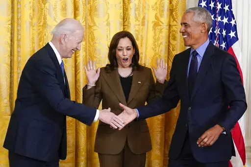 Vice President Kamala Harris reacts as President Joe Biden shakes hands with former President Barack Obama after Obama jokingly called Biden vice president in the East Room of the White House in Washington, Tuesday, April 5, 2022. (AP Photo/Carolyn Kaster)