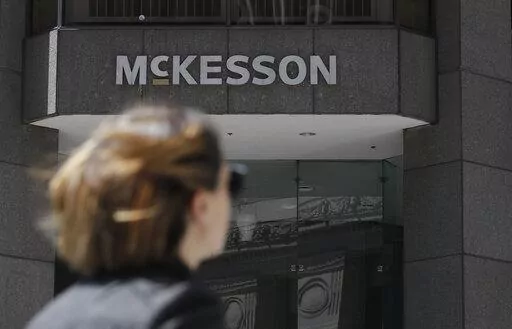 In this July 17, 2019, file photo, a pedestrian passes a McKesson sign on an office building in San Francisco. Native American tribes in the U.S. have reached settlements worth $590 million over opioids. A court filing made Tuesday, Feb. 1, 2022 in Cleveland lays out the details of the settlements with drugmaker Johnson & Johnson and distribution companies AmerisoruceBergen, Cardinal Health and McKesson. (AP Photo/Jeff Chiu, File)