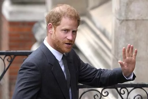Britain's Prince Harry salutes media as he arrives at the Royal Courts of Justice in London, on March 30, 2023. Prince Harry is expected to return to the U.K. next month to attend a charity awards ceremony on the eve of the first anniversary of Queen Elizabeth II’s death. (AP Photo/Kirsty Wigglesworth, File)