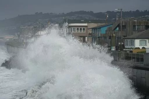 Large waves crash into a seawall in Pacifica, Calif., on Jan. 6, 2023. Giant waves, measuring as high as 13 feet, are becoming more common off California's Pacific coast as the planet warms, according to new research that used a unique approach to gather historical data over the past 90 years to track the increasing height of the surf. (AP Photo/Jeff Chiu, File)