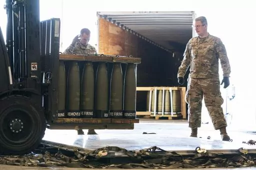 Airmen with the 436th Aerial Port Squadron place 155 mm shells on aircraft pallets ultimately bound for Ukraine, April 29, 2022, at Dover Air Force Base, Del. Half of the people in the U.S. support the Pentagon's ongoing supply of weapons to Ukraine for its defense against Russian forces. That's according to a new survey by the University of Chicago's Harris School of Public Policy and NORC. (AP Photo/Alex Brandon, File)