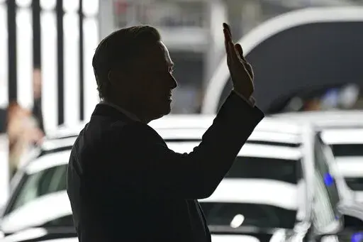 Elon Musk, Tesla CEO, attends the opening of the Tesla factory Berlin Brandenburg in Gruenheide, Germany, Tuesday, March 22, 2022.  Many people are puzzled on what a Elon Musk takeover of Twitter would mean for the company and even whether he’ll go through with the deal.  If the 50-year-old Musk’s gambit has made anything clear it’s that he thrives on contradiction.   (Patrick Pleul/Pool via AP, File)