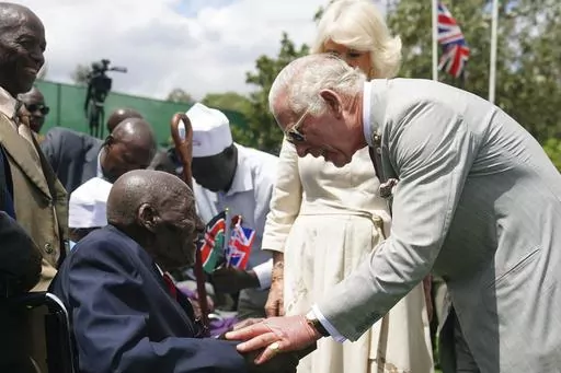 Britain's King Charles III, right, meets veteran Samwel Nthigai Mburia, who is believed to be 117 years old, during a visit to Kariokor World War II Commonwealth Cemetery in Nairobi, Kenya, Wednesday, Nov. 1, 2023. King Charles III has visited a war cemetery in Kenya, laying a wreath in honor of Kenyans who fought alongside the British in the two world wars. It came a day after the British monarch expressed “greatest sorrow and the deepest regret” for the violence of the colonial era. He gav